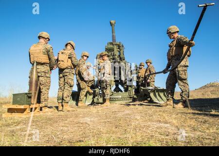 U. S. Marines from Artillery Training School (ATS) Section Chief Course 1-18 conducts a performance evaluation on the operation of the M777  Light Towed Howitzer aboard Camp Pendleton Calif., 22, Jan 2018. The section chiefs course enables Marines who show leadership potential to become supervisors of an M777 operations team. Stock Photo