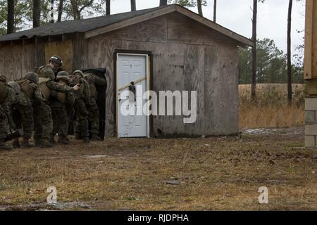 Marines in an Assaultman Course with the Infantry Training Battalion, School of Infantry East, prepare to detonate an explosive at ETA-8A engineer demolition training range and urban breaching facility on Marine Corps Base Camp Lejeune, N.C., Jan. 12, 2018. The exercise was held to demonstrate different demolition and explosive breaching training techniques, and to develop proficiency in mobility support for infantry units. Stock Photo