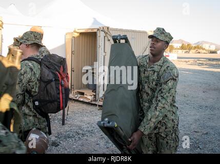 FUJAIRAH, United Arab Emirates (Jan. 13, 2018) Hospital Corpsman 2nd Class Nathaniel Williams, a U.S. Navy Sailor attached assigned to Amphibious Construction Battalion 1, moves equipment into the battalion aid station during Native Fury 18. The exercise is designed to train Special Purpose Marine-Air-Ground Task Force-Native Fury Marines and U.S. Navy Sailors in maritime prepositioning force operations and aims to increase proficiency, expand levels of cooperation, enhance maritime capabilities, and promote long-term regional stability and interoperability between the United Arab Emirates and Stock Photo