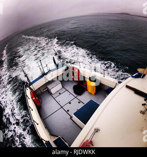 Dive boat coming in for pickup Stock Photo