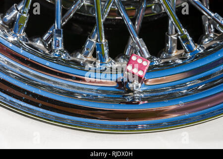 Lucky Dice on a chrome car rim Stock Photo