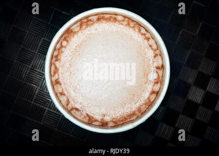 Hot chocolate cocoa drink close up macro foam texture on dark background Stock Photo