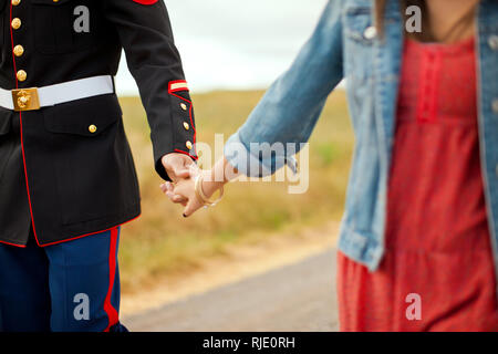 Young couple holding hands outdoors. Stock Photo