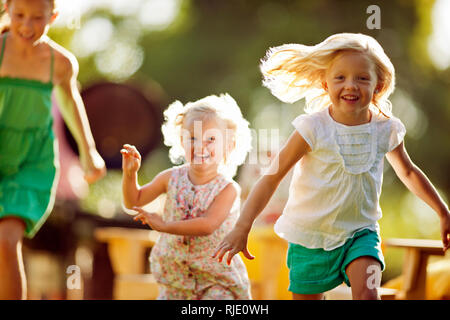 Happy siblings playing in their backyard. Stock Photo