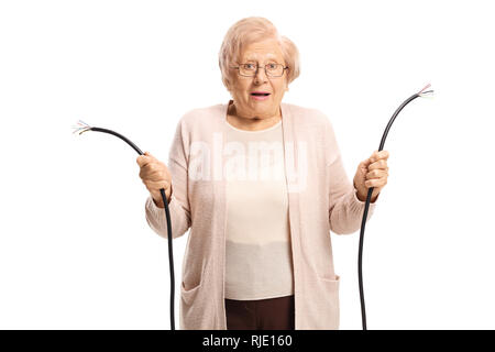 Confused old lady holding a broken cable isolated on white background Stock Photo