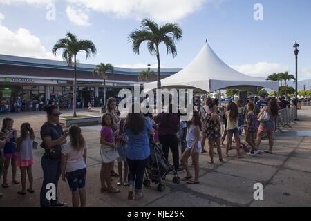 Fans wait in line during a United Services Organization (USO) meet and greet event with Gabrielle “Gabby” Douglas at the Mokapu Mall, Marine Corps Base Hawaii, Jan. 14, 2018. This event was the final stop in the USO tour where Douglas met with Service members and their families to help raise morale. Stock Photo
