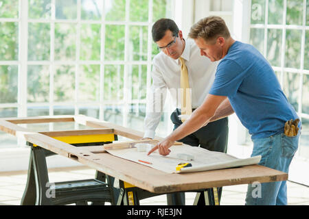 Businessman and contractor working together on a project. Stock Photo