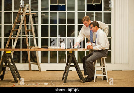 Two businessmen eating Chinese food while working late on a project. Stock Photo