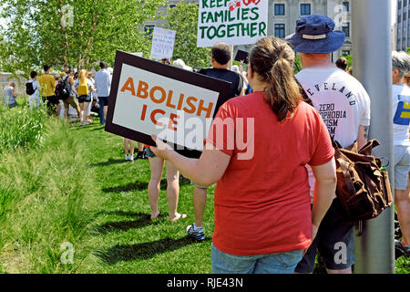 A woman holds an 'Abolish ICE' sign at a June 20, 2018 rally in Cleveland, Ohio, USA demonstrating against Trump immigration policy changes.