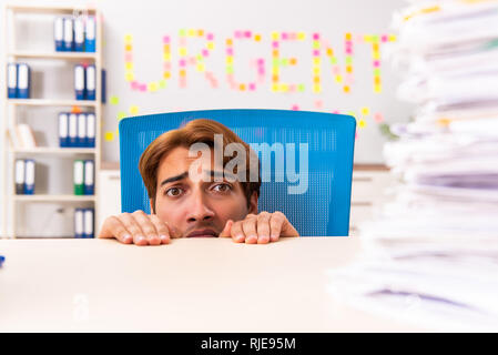 Young employee suffering from excessive work Stock Photo
