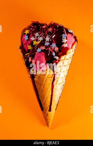 Tasty big cherry ice-cream with chocolate topping Stock Photo
