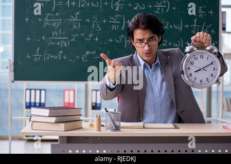 Young handsome math teacher in classroom Stock Photo