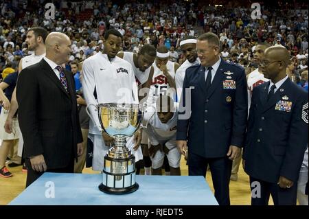 U.S. Air Force Maj. Gen. Bill Hyatt, U.S. Air Force Warfare Center commander, and Chief Master Sgt. Robert Ellis, U.S. Air Force Warfare Center command chief, stand with Andre Iguodala, USA Olympic Men's Basketball player, during the presentation of the player of the game award after an exhibition game against the Dominican Republic national team, July 12, 2012, at the Thomas and Mack Center, Las Vegas, Nev. Igoudala and the USA Olympic Basketball team are ready to continue  to the Olympic games in London, England. Stock Photo