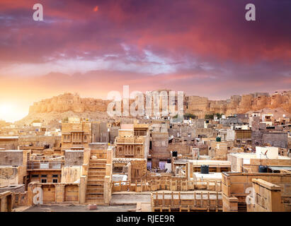 Purple vibrant sunset at indian desert city with Jaisalmer fort in Rajasthan, India Stock Photo