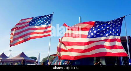 on Thanksgiving Day the flag of the United States of America flies with the wind of freedom in the blue sky and defends all American citizens Stock Photo