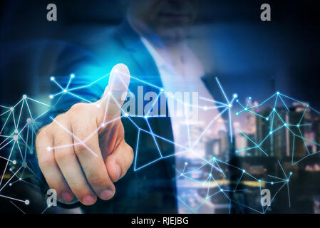 Business man point finger to global futuristic technology network Stock Photo