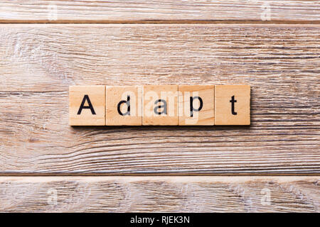 ADAPT word written on wood block. ADAPT text on wooden table for your desing, concept. Stock Photo