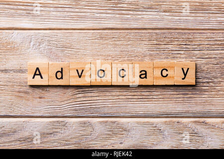 ADVOCACY word written on wood block. ADVOCACY text on wooden table for your desing, concept.