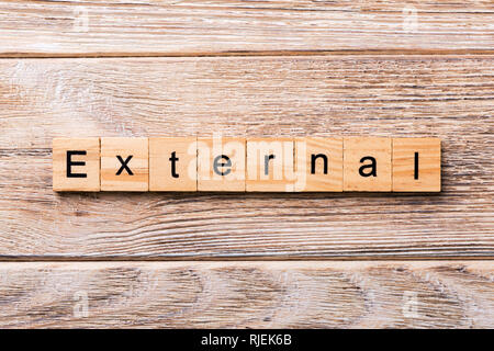 EXTERNAL word written on wood block. EXTERNAL text on wooden table for your desing, concept. Stock Photo