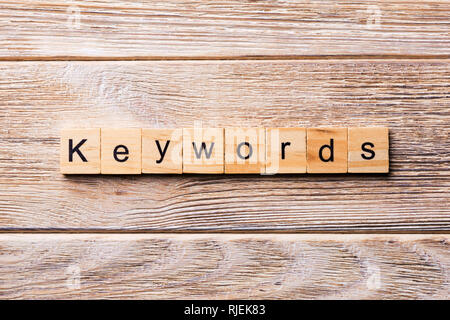 KEYWORDS word written on wood block. KEYWORDS text on wooden table for your desing, concept. Stock Photo