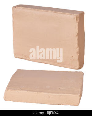 Pieces of  beige plasticine clay on a white background Stock Photo