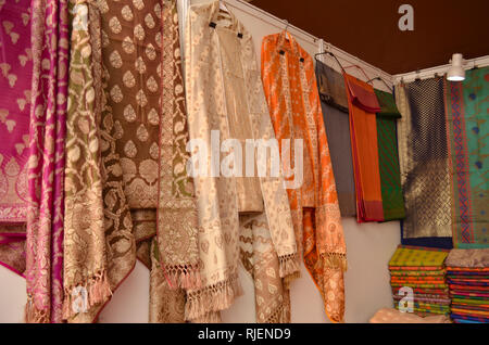 Fancy Indian Chanderi silk suits hanging on display in a Swadeshi Khadi Handloom exhibition at Delhi Haat, Delhi, India Stock Photo