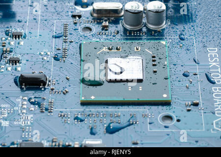 Electrical circuit mother board with water drops. Close up image, selective focus Stock Photo