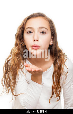 Young girl blowing a kiss to the camera isolated on white background Stock Photo