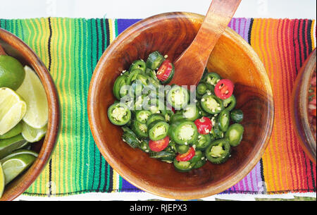 Wooden bowl with sliced jalapenos  above top view Stock Photo
