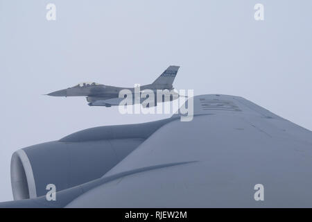 An F-16 from the South Carolina Air National Guard's 169th Fighter Wing flies alongside a Tenneessee Air National KC-135 Stratotankerfrom the 134th Air Refueling Wing during a media flight Jan. 29, 2019. (U.S. Air National Guard photo by Capt. Stephen D. Hudson) Stock Photo