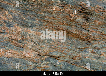 Gneiss, a common type of metamorphic rock, is formed by high temperature and high-pressure metamorphic processes acting on the formation of igneous or Stock Photo