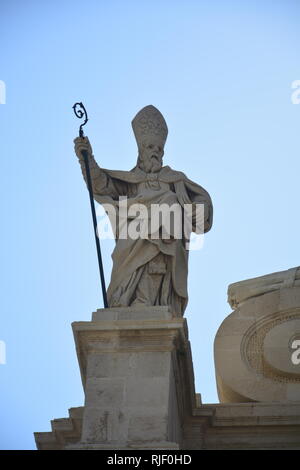 Bishop's statue on cathedral in Syracuse Stock Photo