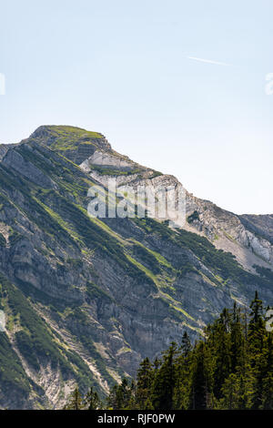 overgrown textured peak in the bavarian alps in sunlight Stock Photo