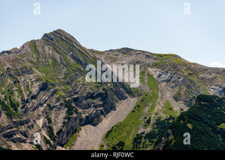 overgrown textured peak in the bavarian alps in sunlight Stock Photo