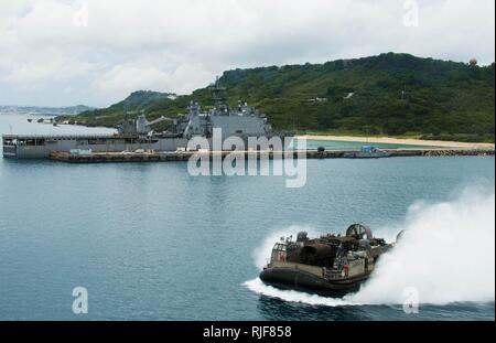 OKINAWA, Japan (Aug. 28, 2015) Landing Craft Air Cushion (LCAC) 9, assigned to Naval Beach Unit (NBU) 7 passes the amphibious dock landing ship USS Ashland (LSD 48). LCAC 9 offloaded the 31st Marine Expeditionary Unit's (31st MEU) equipment from the well deck of the amphibious transport dock ship USS Green Bay (LPD 20). Green Bay and Ashland are assigned to the Bonhomme Richard Expeditionary Strike Group and are on patrol in the U.S. 7th Fleet area of operations. Stock Photo
