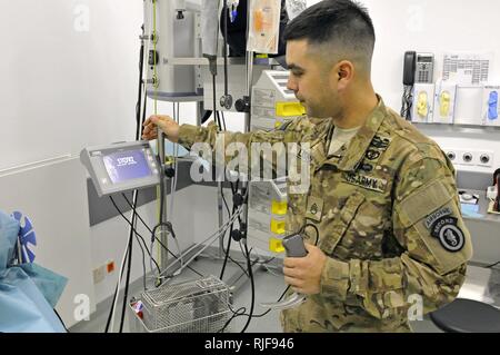 U.S. Army SSgt Nicholas Lising operates a Storz Endoscope in one of the trauma care rooms at the Field Medical Station on Camp Marmal. Lising, of the 8th Forward Surgical Team (Airborne), is currently serving his seventh deployment in ten years of service as an Operating Room Technician. His efforts are a direct contribution to the overall mission of ISAF. International Security Assistance Force Regional Command North supports ANSF in close coordination and collaboration in providing security and disrupting the insurgents' activities in order to protect the population, secure the highways and  Stock Photo