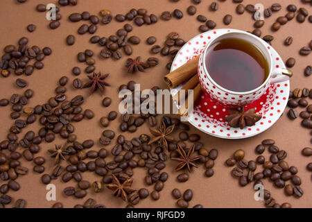 spicy black coffee polka dot mug and coffee beans mess on brown  background Stock Photo