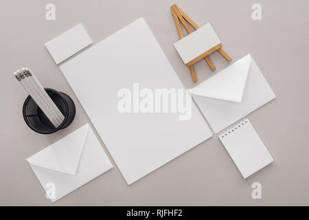 flat lay with blank cards and stationery on grey background Stock Photo