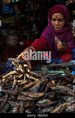 Kathmandu, Nepal, Nepal. 17th Aug, 2018. A lady seen selling dry fish at a market in Kathmandu, Nepal.Kathmandu is the capital city of Nepal. Its is a colourful city with many markets and temples. It lies at the base of the Himalayas and many climbers begin their journeys from it. Credit: Enzo Tomasiello/SOPA Images/ZUMA Wire/Alamy Live News Stock Photo