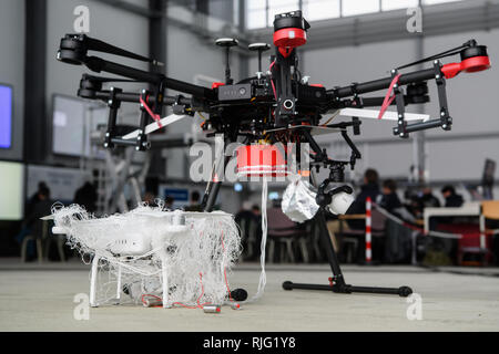 Manching, Germany. 06th Feb, 2019. A drone captured by an AirRobot AR200 (rear) fighter drone is shown at a German Armed Forces presentation day to track down and fend off drones. During a presentation day at the Manching airfield near Ingolstadt, it will be demonstrated how the flying objects can be detected, forced to an emergency landing with interference radiation or taken down from the sky with an interceptor drone. Credit: Matthias Balk/dpa/Alamy Live News Stock Photo