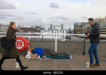 London, UK. 6th Feb, 2019. A Homeless person sleeping on London Bridge as the government has pledged £100m over two years to tackle rough sleeping as Secretary of State for housing James Brokenshire has vowed to end rough sleeping by 2027 and wants to help people turn their lives around and support for mental health and addictions. Credit: amer ghazzal/Alamy Live News Stock Photo