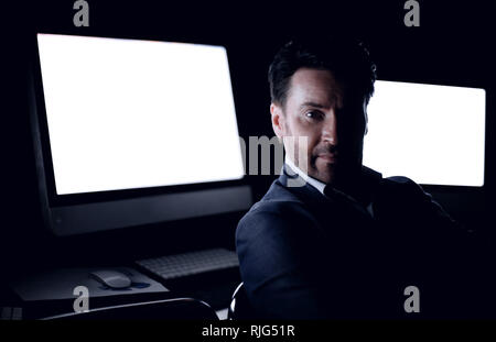 tired businessman working in the computer room late. Stock Photo