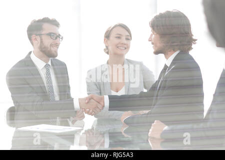 from behind the glass.handshake of business partners Stock Photo