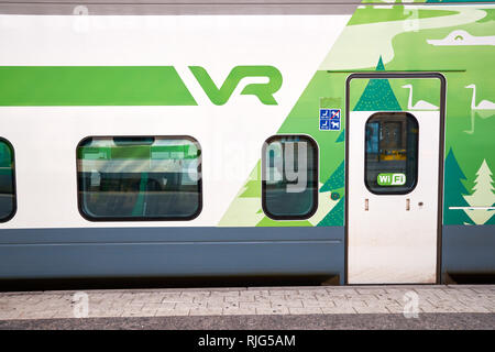 HELSINKI, FINLAND - SEPTEMBER 21, 2014: train at Helsinki Central railway station. It is a widely recognised landmark in Kluuvi, part of central Helsi Stock Photo