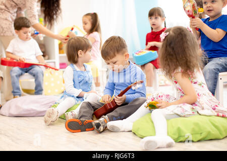 Group of kids playing musical toys. Early musical education in kindergarten or primary school Stock Photo