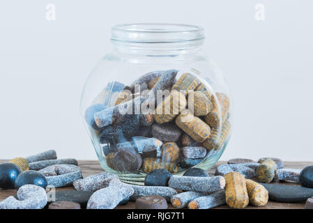 Candy jar in centre of table  filled with assorted salmiakki Stock Photo