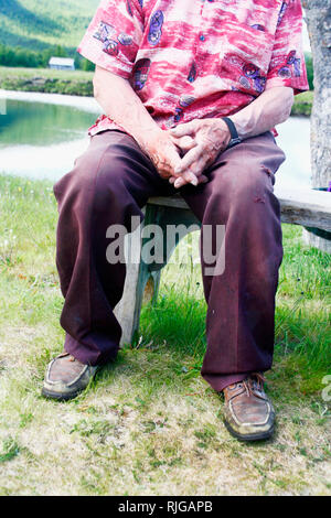 Senior man sitting on bench Stock Photo