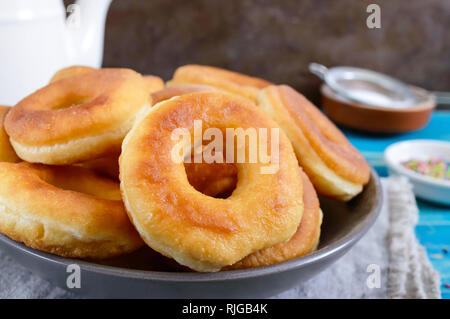 Homemade classic donuts with powdered sugar in the plate. Stock Photo