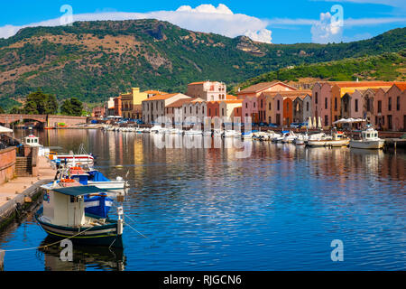 Bosa, Sardinia / Italy - 2018/08/13: Panoramic view of the old town quarter of Bosa by the Temo river embankment with colorful tenement houses and boa Stock Photo
