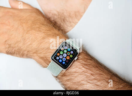 PARIS, FRANCE - JUN 30, 2018: Apple Watch series 3 on man hairy hand - display showing all apps for the WatchOS Stock Photo